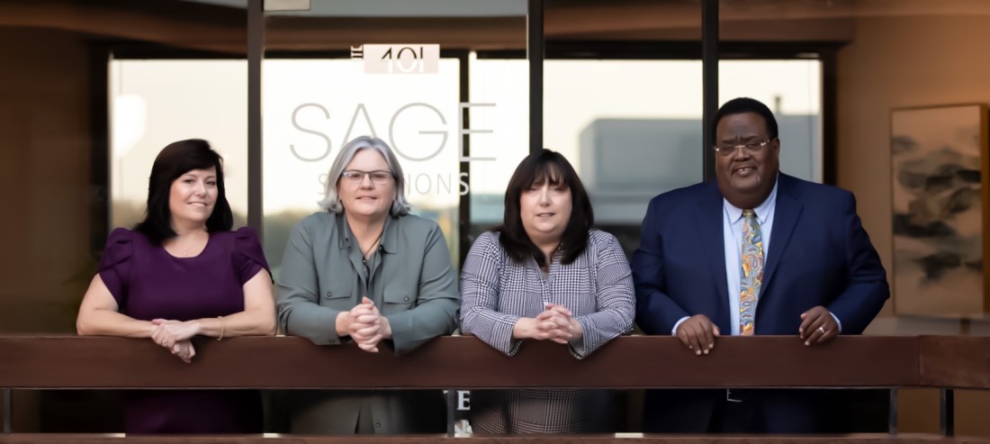 Four HR consultants from Sage Solutions Group looking at the camera
