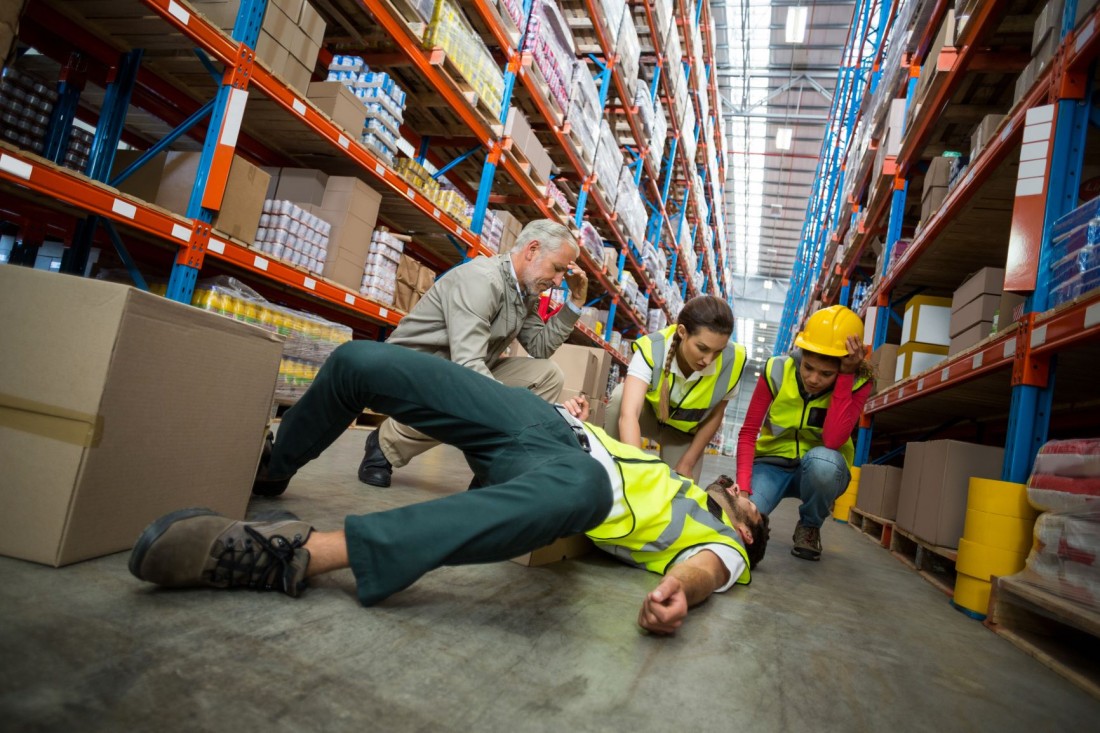 worker fallen after a workplace accident in a warehouse